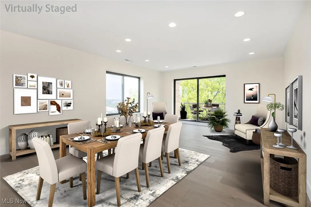 Dining area open to the kitchen with wood finished floors and recessed lighting