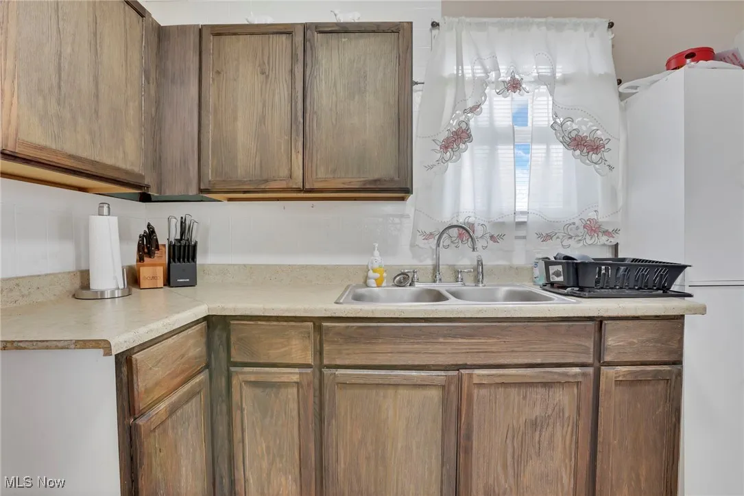 Kitchen with light countertops and a sink