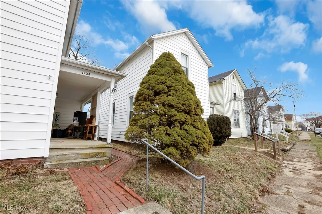 View of home's exterior with a residential view and a porch