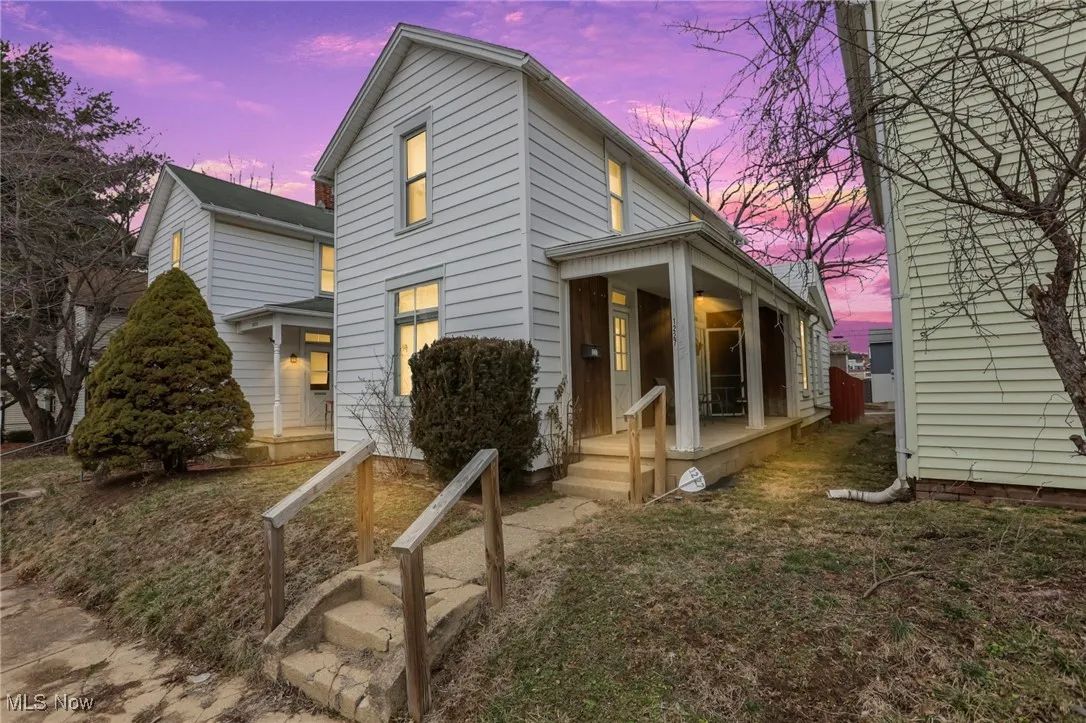 Back of house featuring covered porch