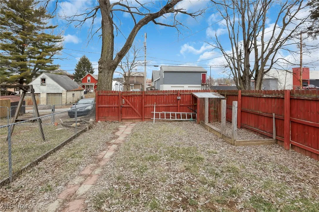 View of yard featuring a gate and a fenced backyard