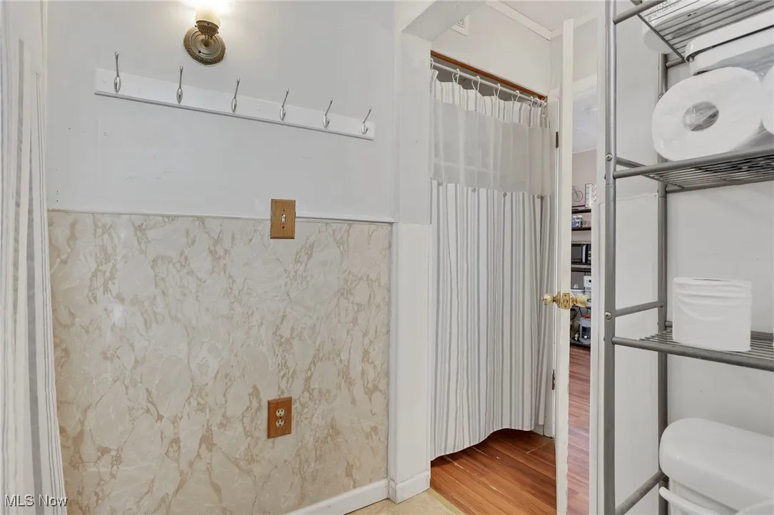 Bathroom with toilet and wood finished floors