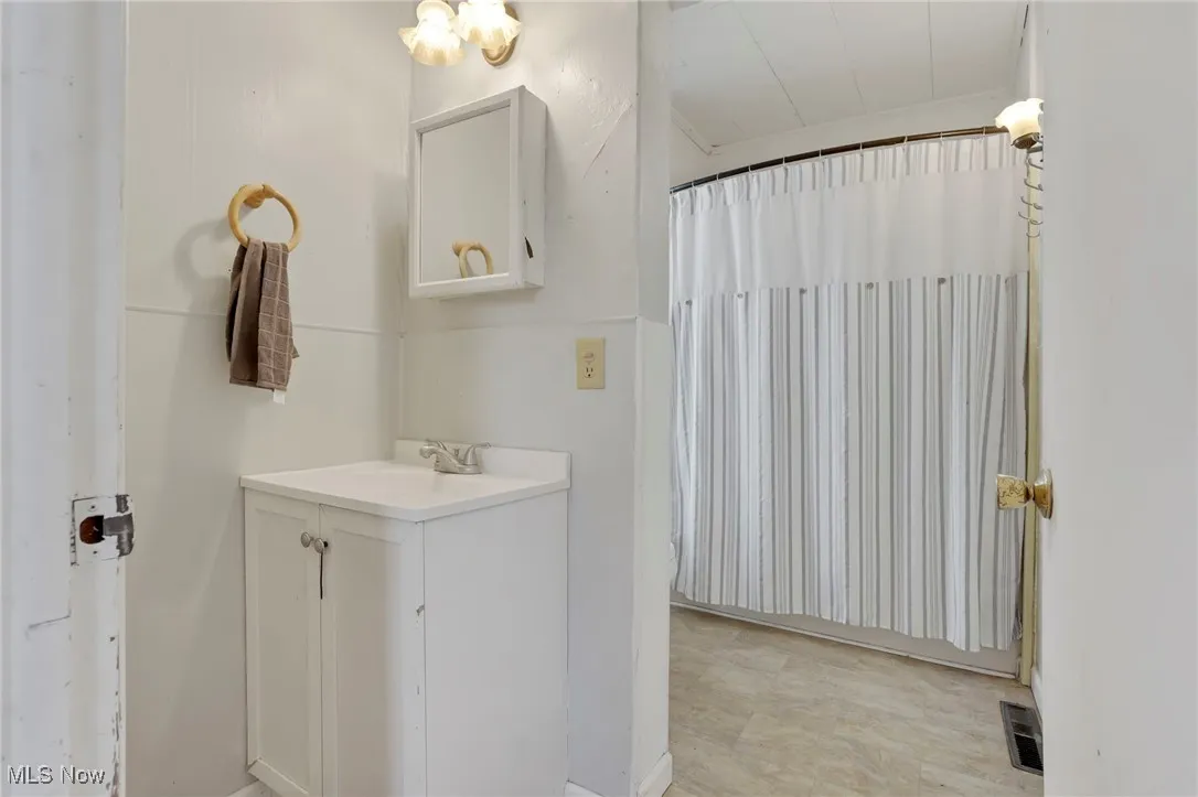 Full bath featuring vanity and visible vents