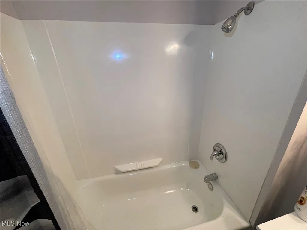 Bathroom with shower / tub combo with curtain