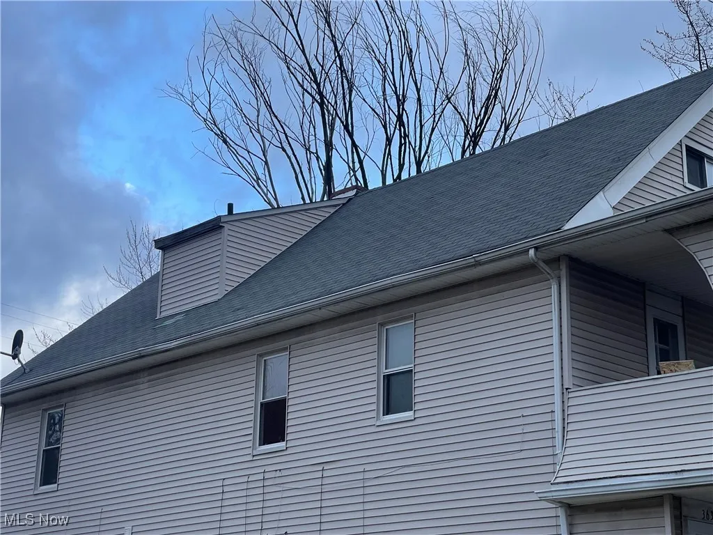 View of home's exterior featuring roof with shingles