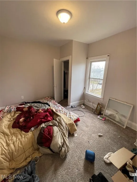 Carpeted bedroom with baseboards