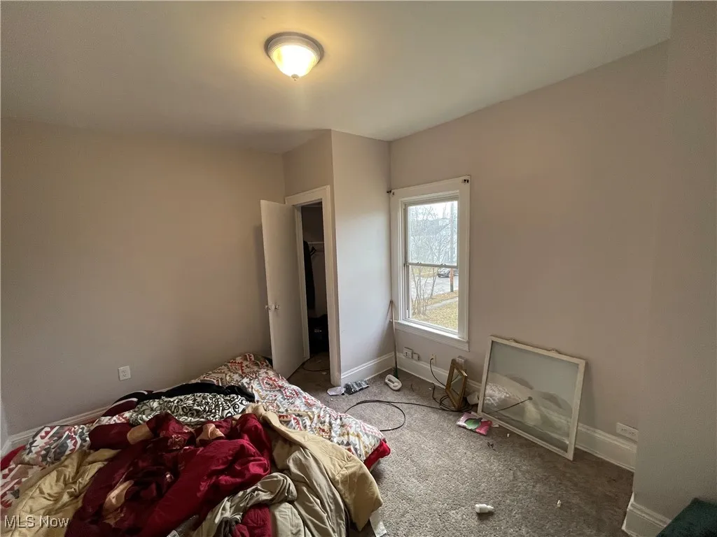 Carpeted bedroom with baseboards