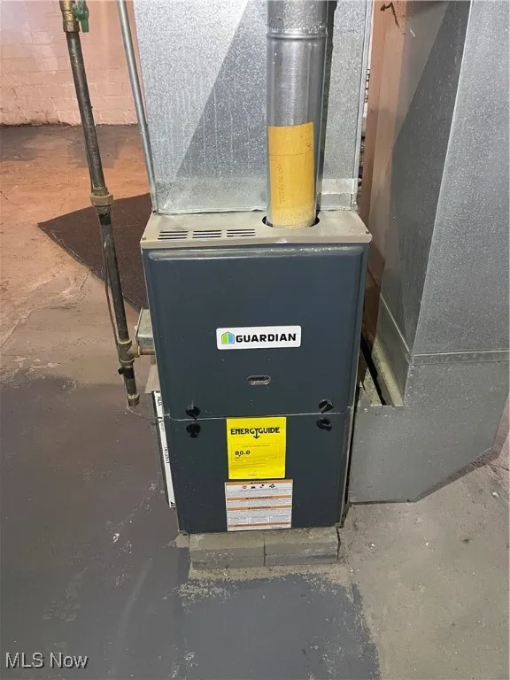 Utility room featuring heating unit