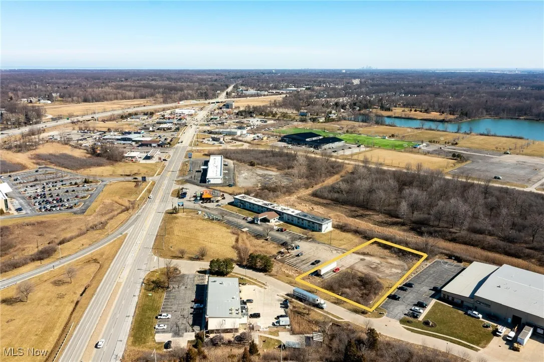 Birds eye view of property with a water view