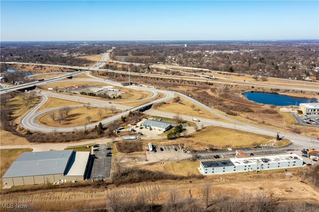 Birds eye view of property with a water view