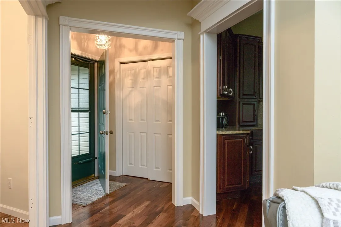 Hall with baseboards and dark wood finished floors