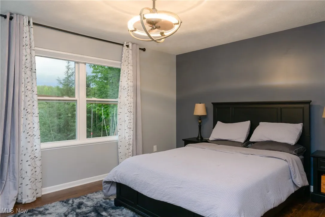 Bedroom featuring wood finished floors and baseboards