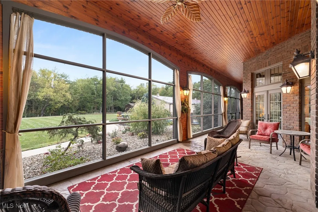 Sunroom / solarium featuring a wealth of natural light and wooden ceiling
