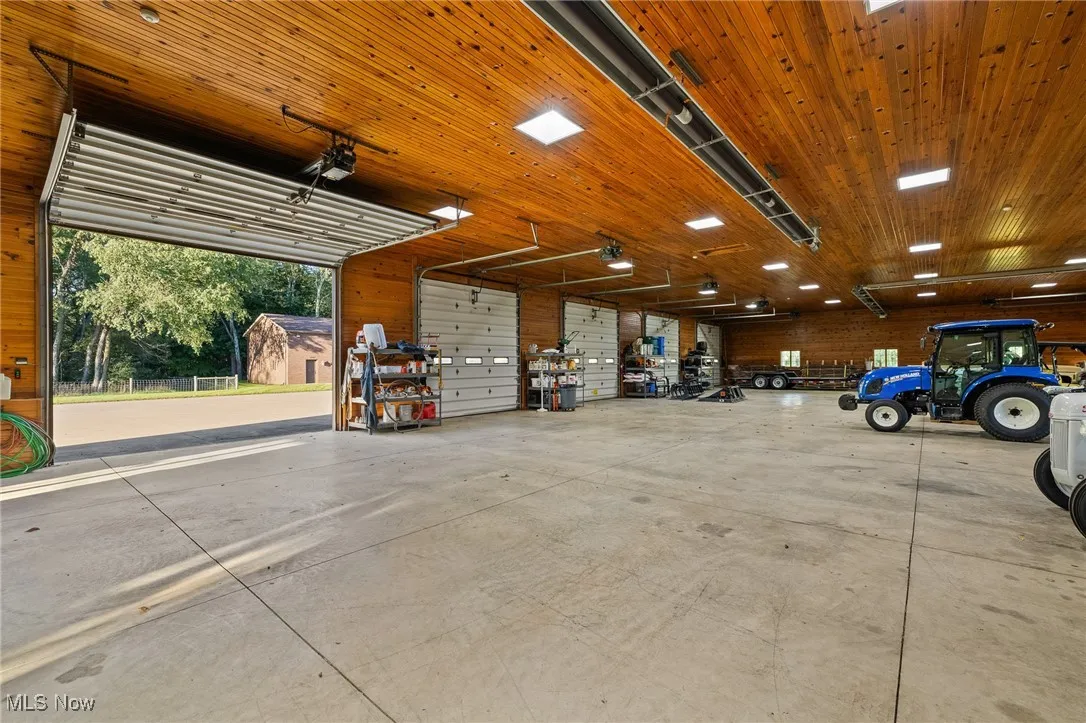 Garage featuring wooden ceiling and a garage door opener