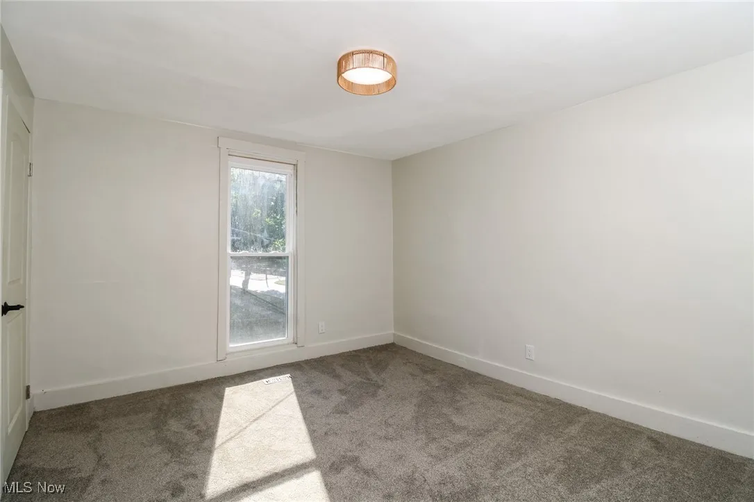Bedroom with new carpet and ample light.
