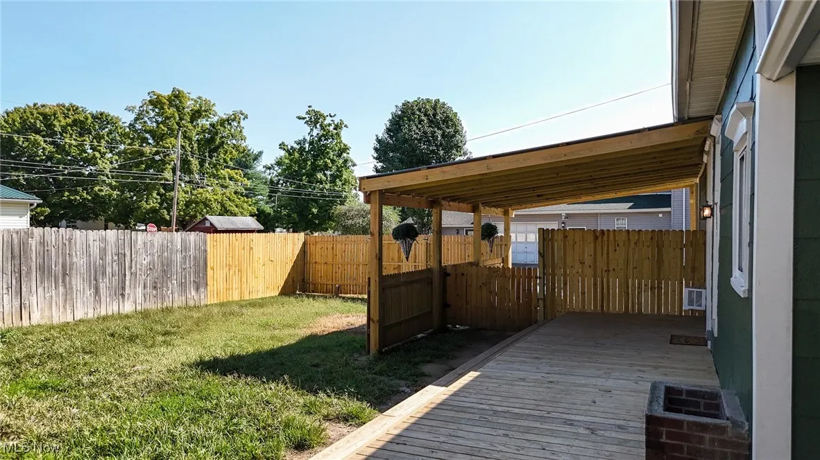 Deck with a lawn and fence