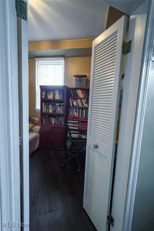 Bedroom featuring dark wood finished floors and a textured ceiling