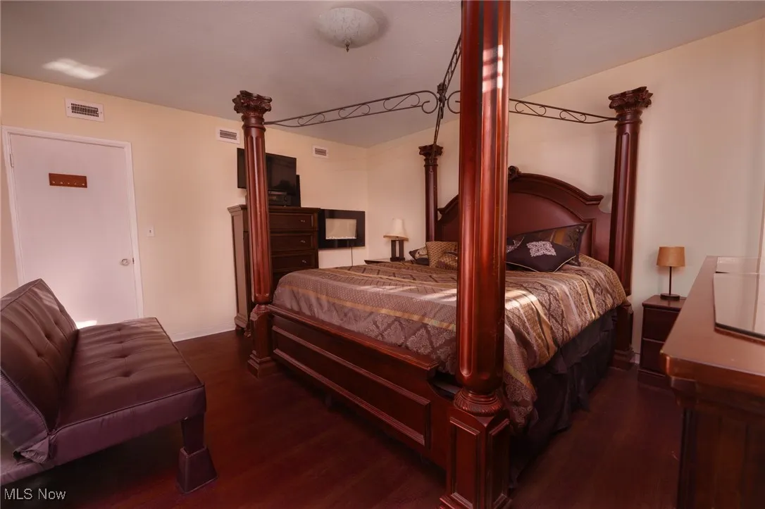 Bedroom featuring visible vents and wood finished floors