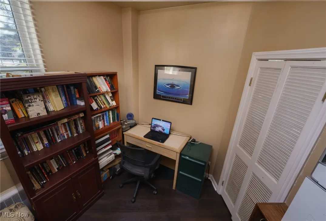Office space featuring dark wood-style floors and baseboards