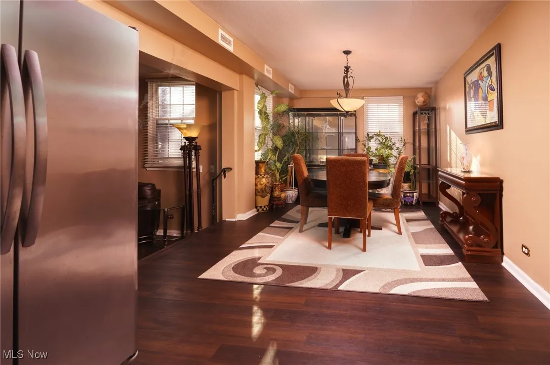 Dining area with wood finished floors, baseboards, and a wealth of natural light