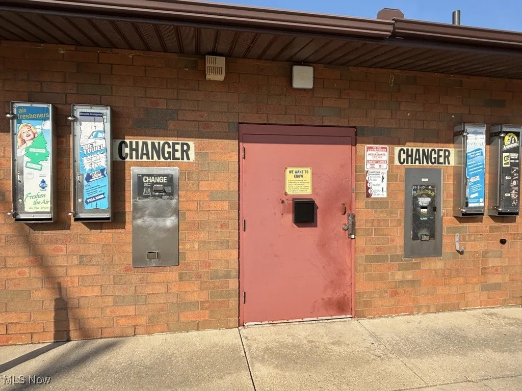 Property entrance featuring brick siding