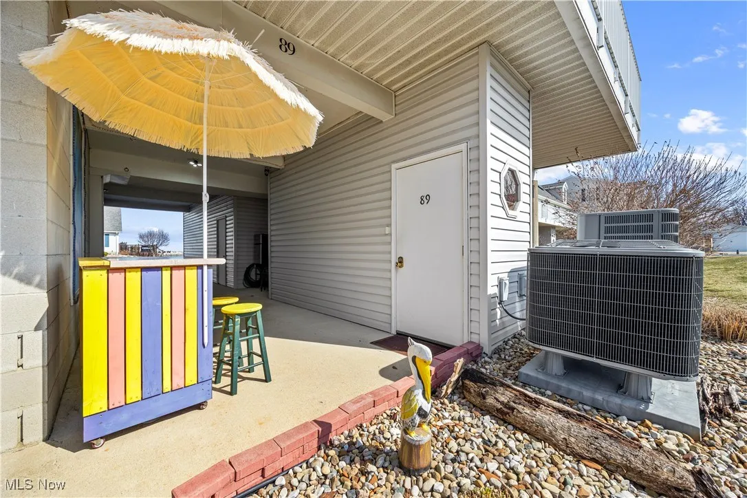 View of patio / terrace featuring cooling unit and outdoor dry bar