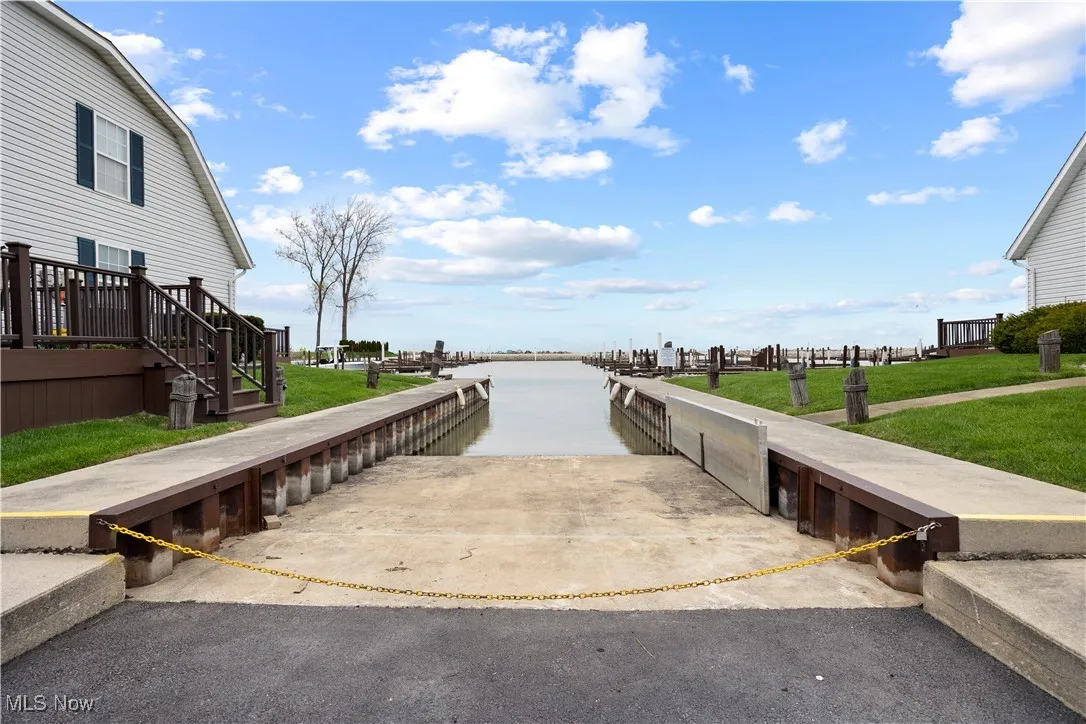 View of dock featuring a yard and a water view