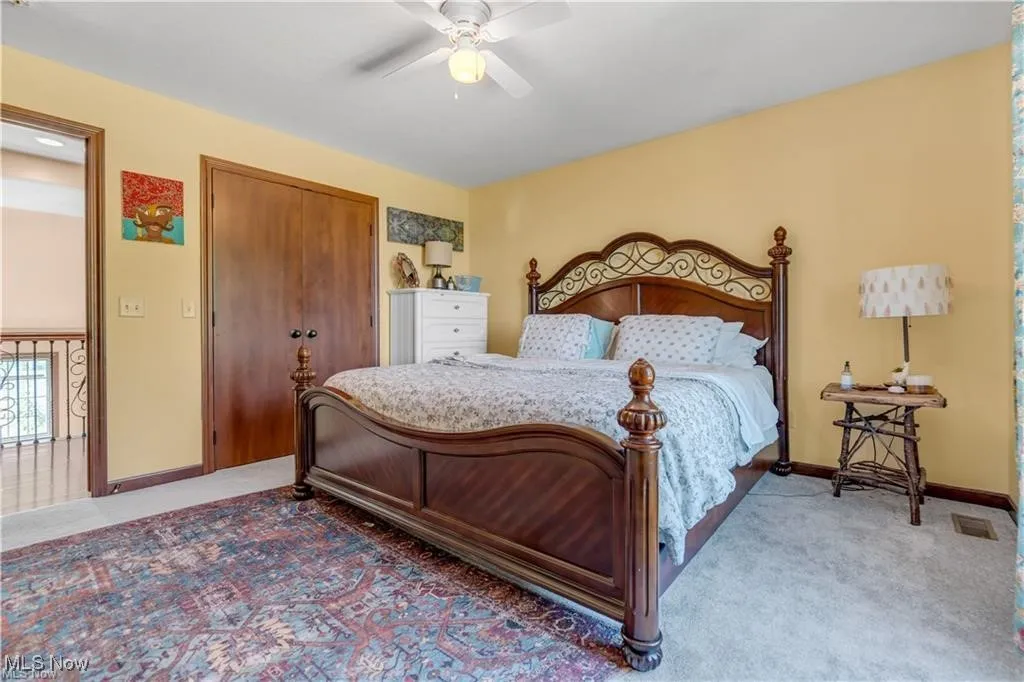 Bedroom featuring visible vents, a ceiling fan, a closet, carpet flooring, and baseboards