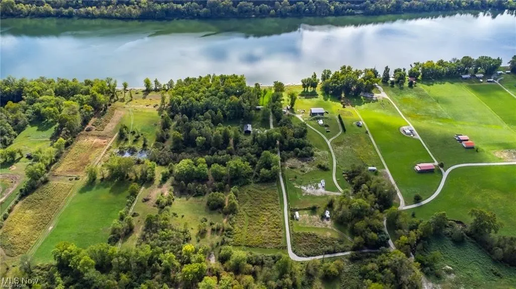 Birds eye view of property with a water view