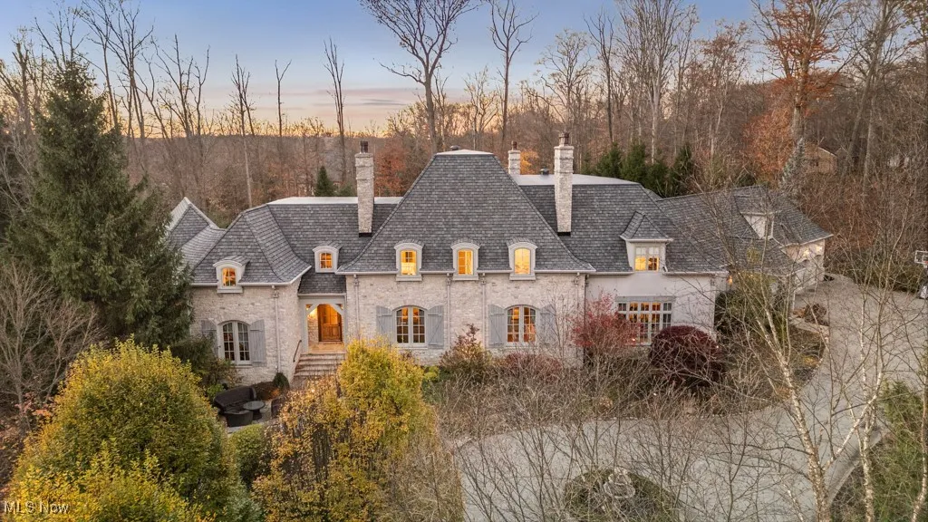 French country home with a chimney