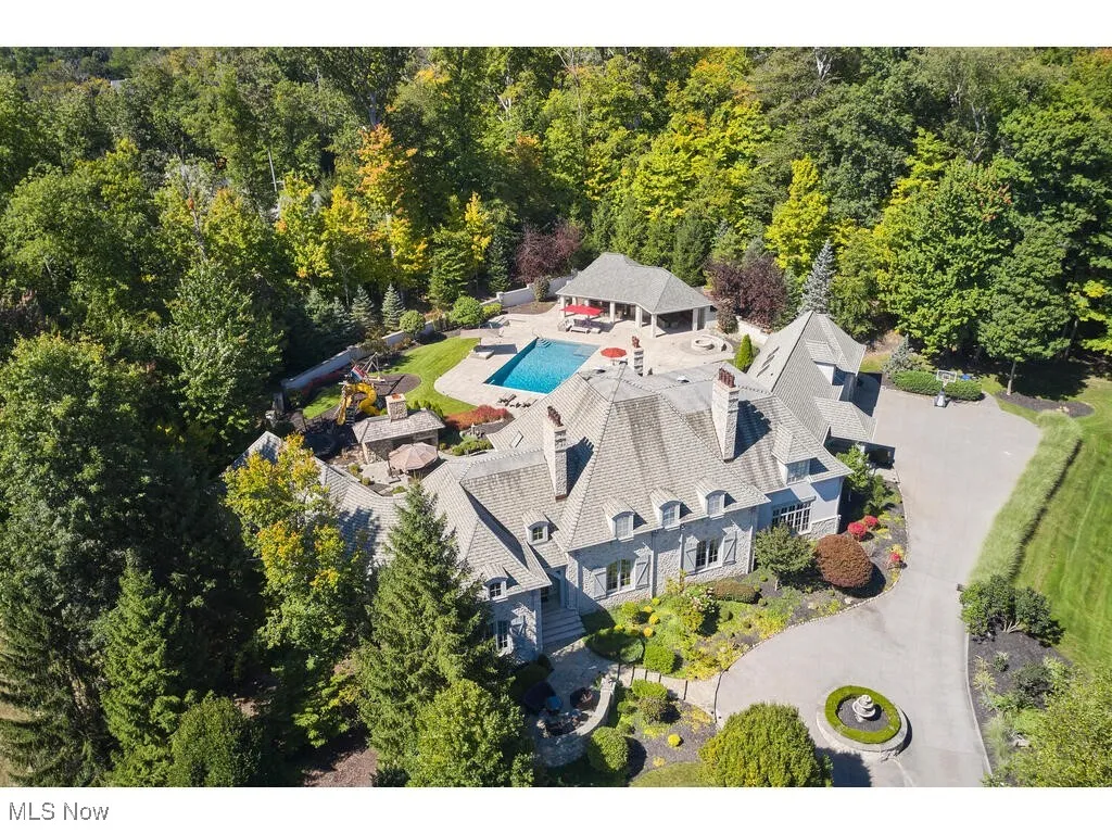 Birds eye view of property featuring a view of trees