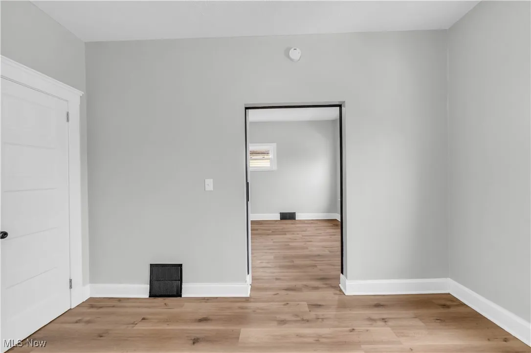 Empty room with baseboards and light wood-style floors