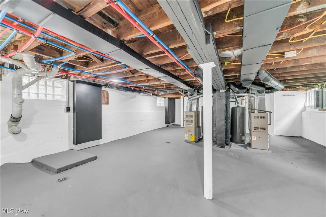 Below grade area with heating unit and water heater