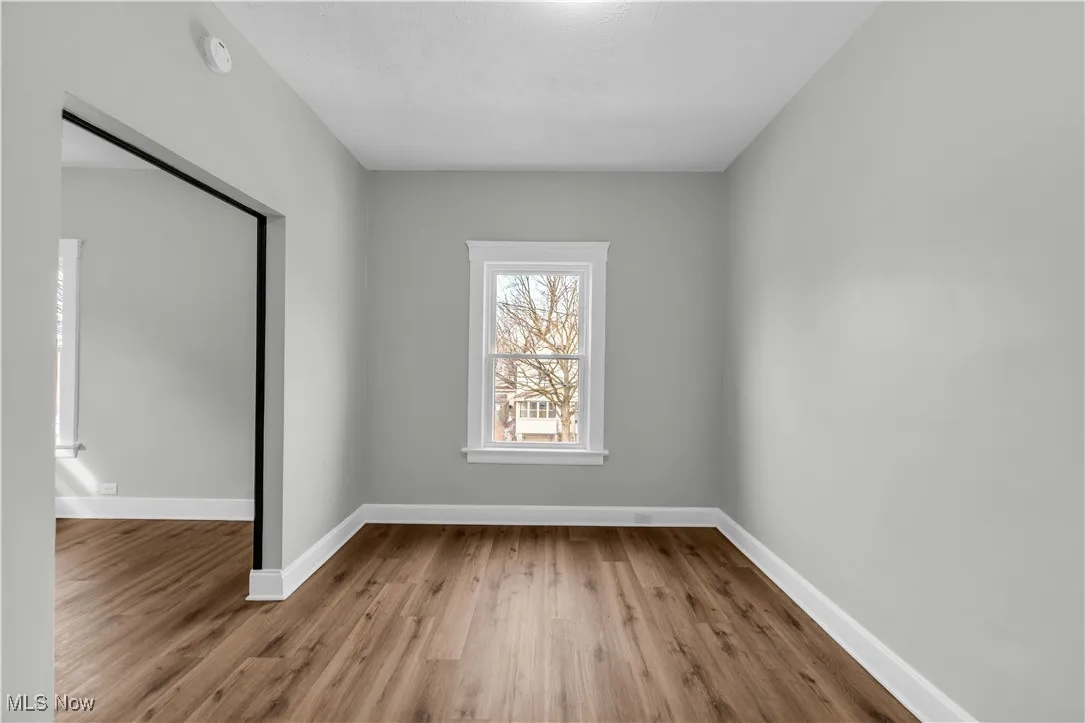 Unfurnished room with baseboards and wood finished floors