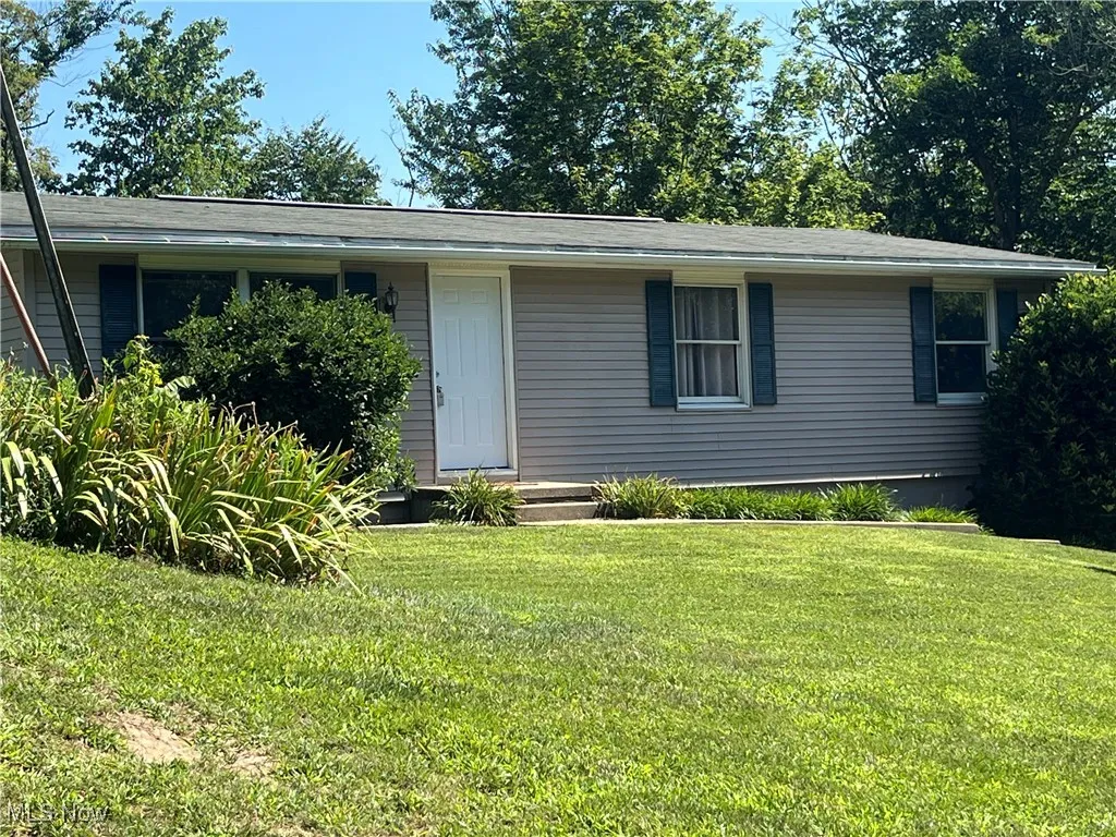 Single story home featuring a front lawn