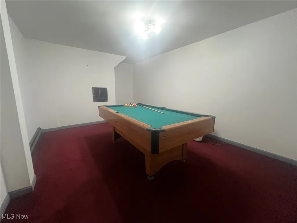 Recreation room with pool table, carpet flooring, and baseboards