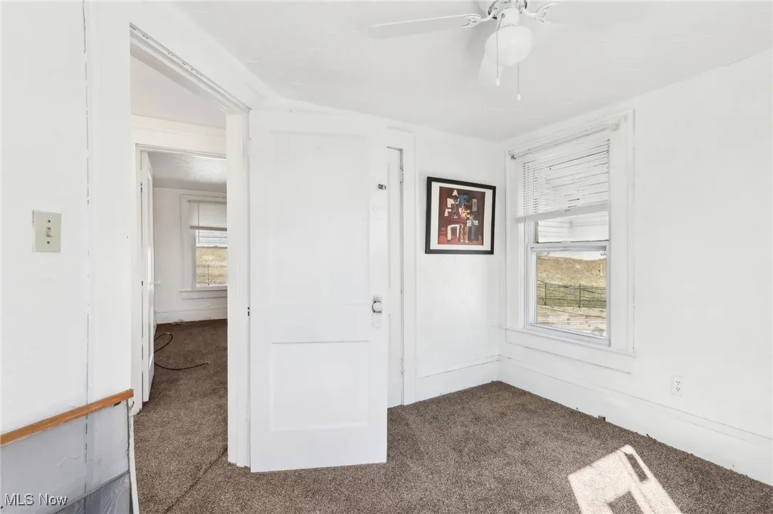 Spare room with carpet flooring and a ceiling fan
