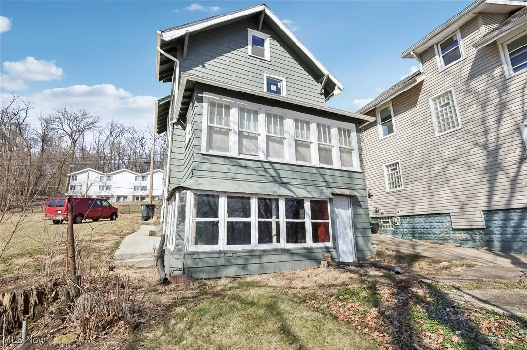 Rear view of house with a sunroom