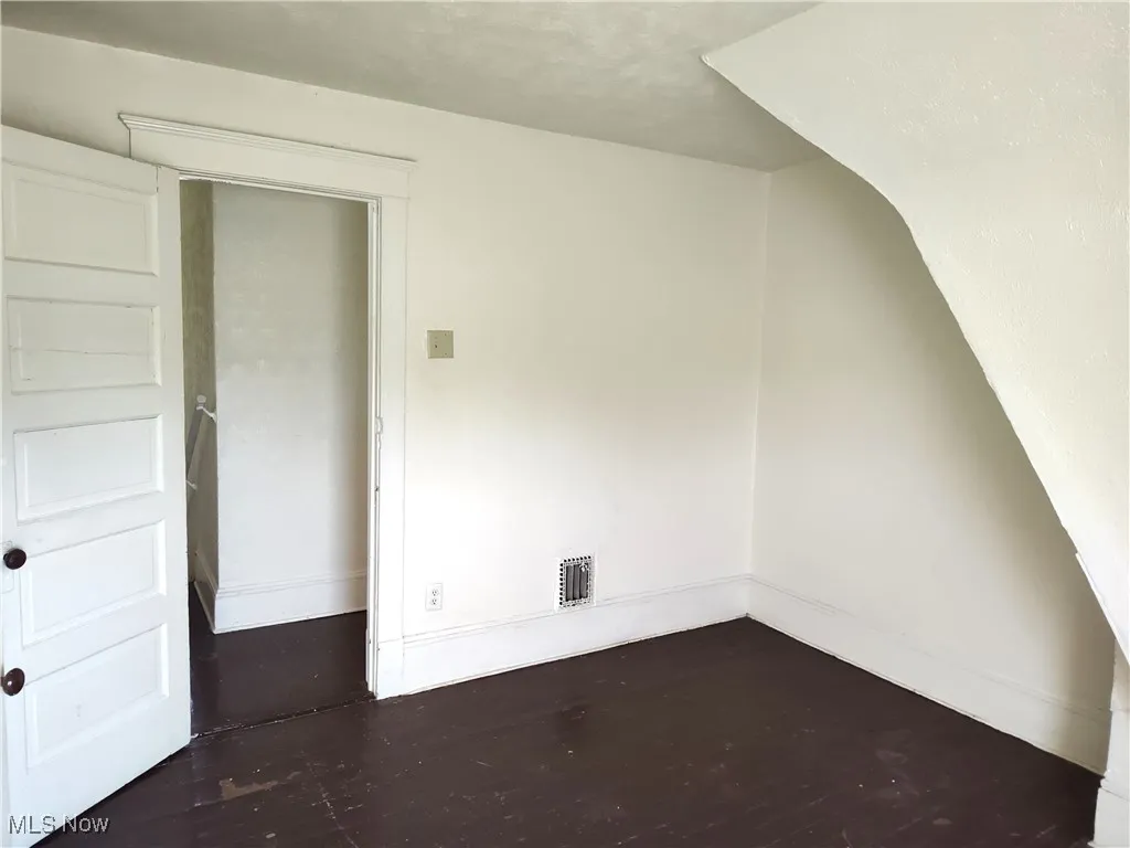Bonus room featuring visible vents, baseboards, and wood finished floors