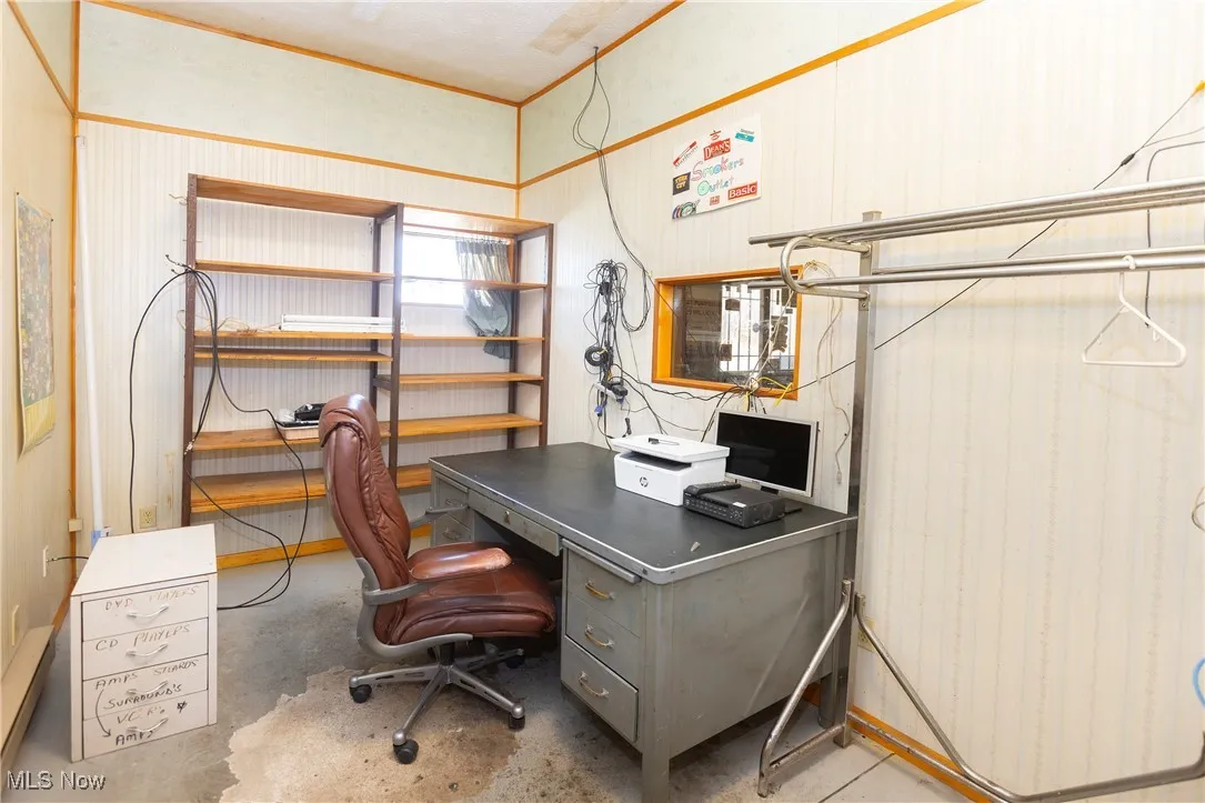 Office space featuring unfinished concrete flooring