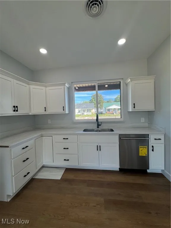 Kitchen with white cabinetry, dishwashing machine, dark wood-style floors, and recessed lighting