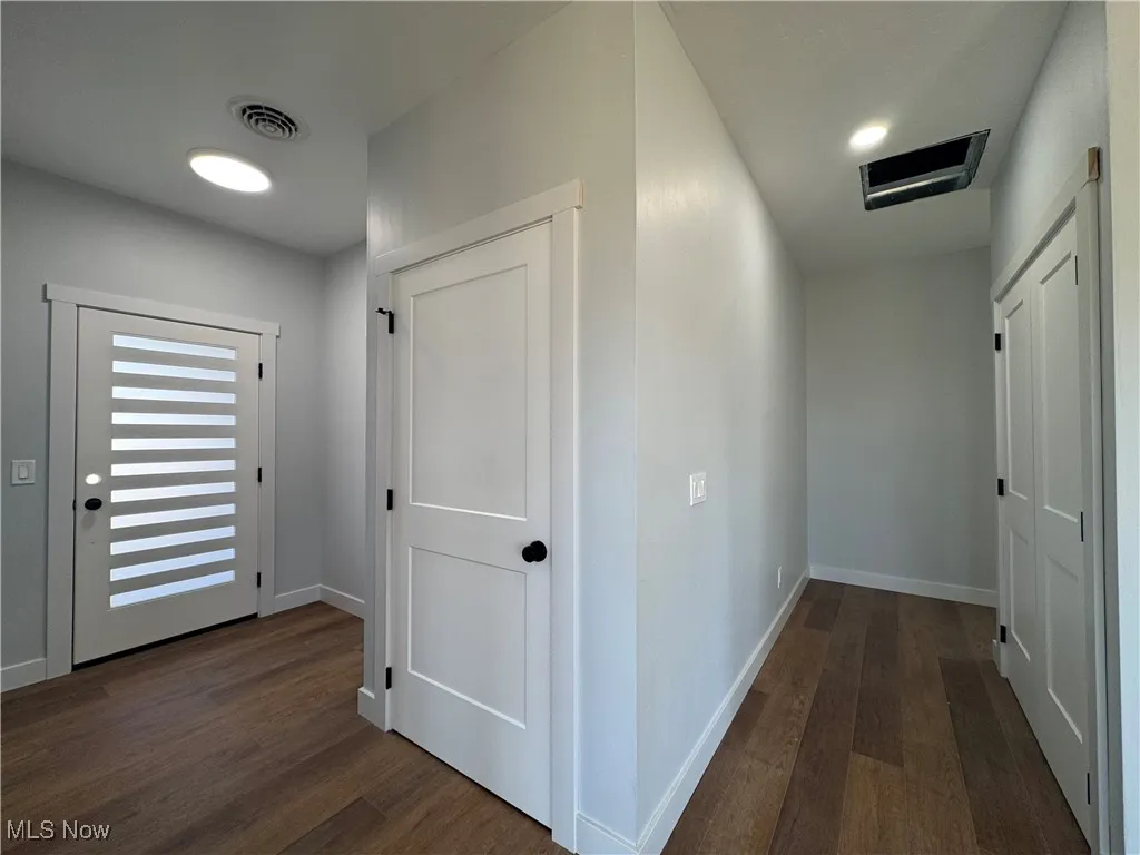 Hall featuring cooling unit, dark wood-style floors, and recessed lighting