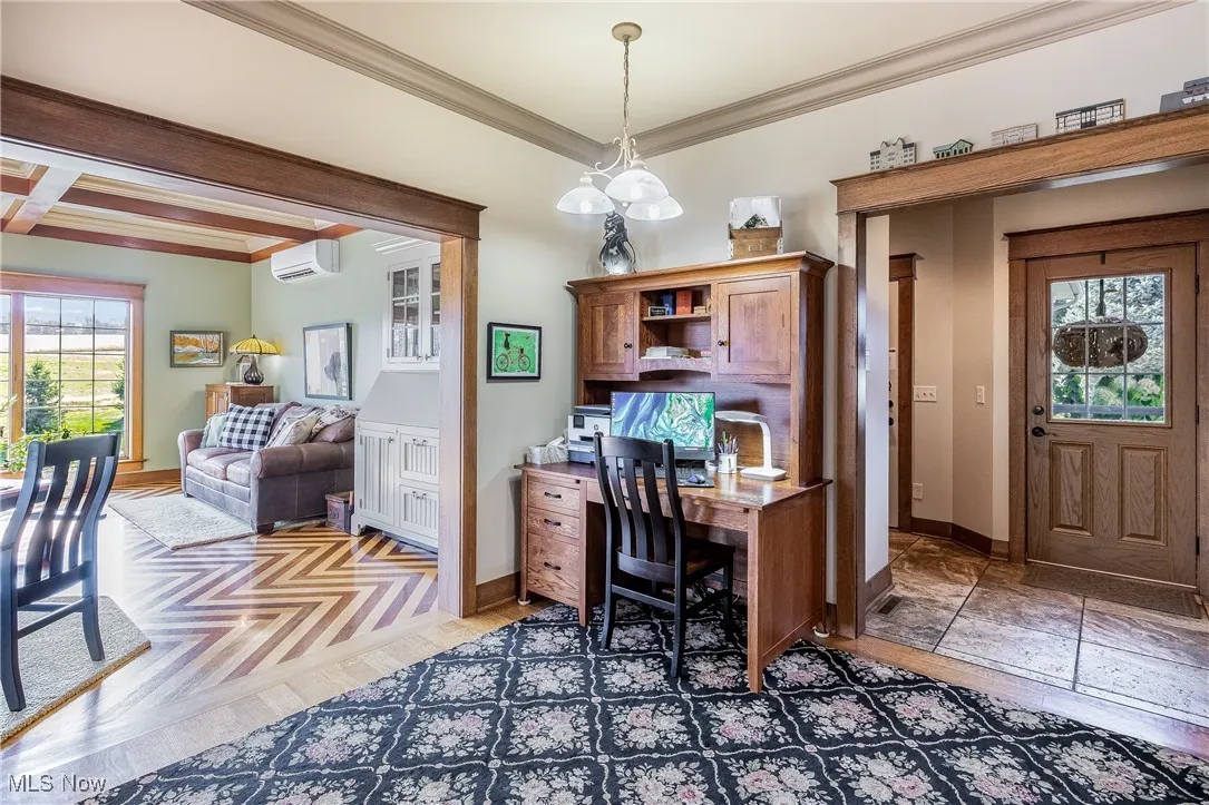 Office space with baseboards, a wall mounted AC, and crown molding