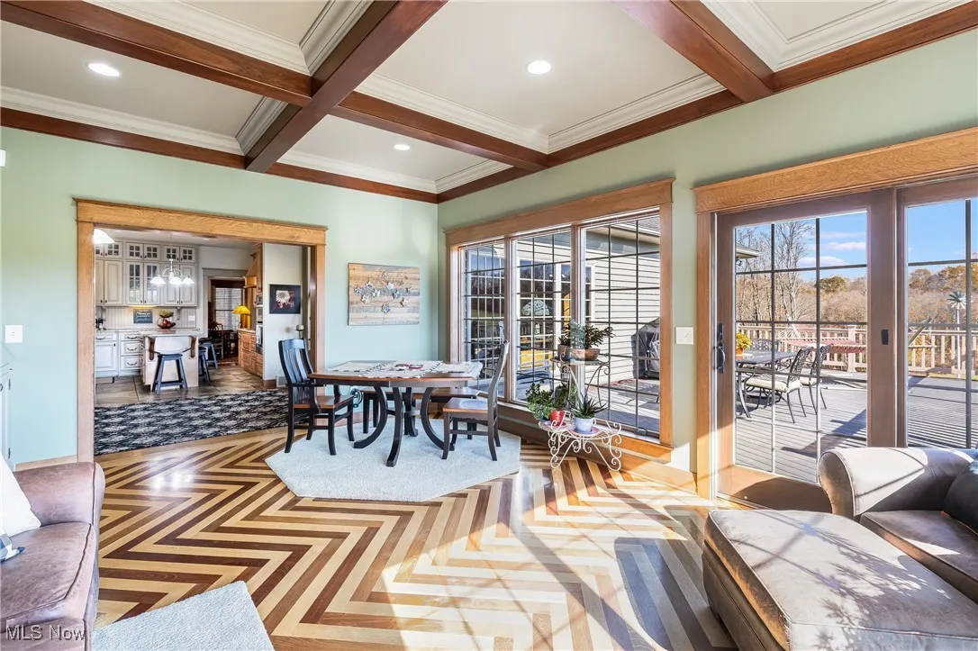 Dining room featuring crown molding, recessed lighting, coffered ceiling, and beamed ceiling