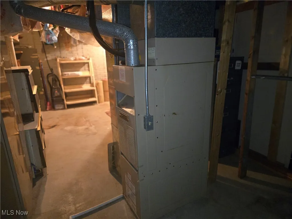 Utility room featuring heating unit