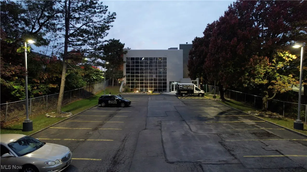 Uncovered parking lot featuring fence