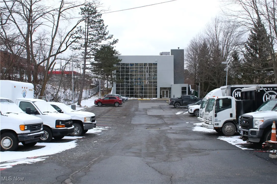 Snow covered parking area featuring uncovered parking