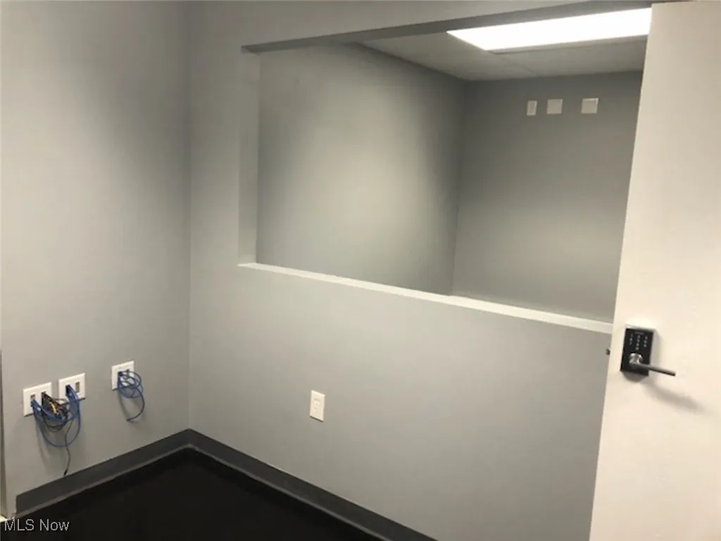 Spare room featuring baseboards and a drop ceiling