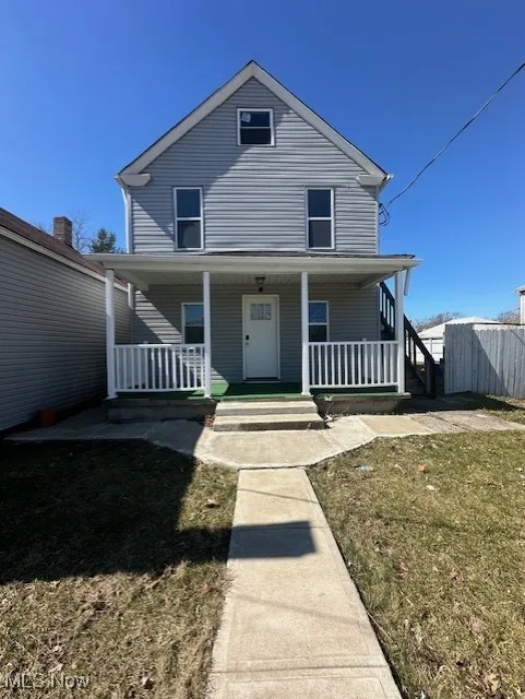View of front of house featuring fence and covered porch