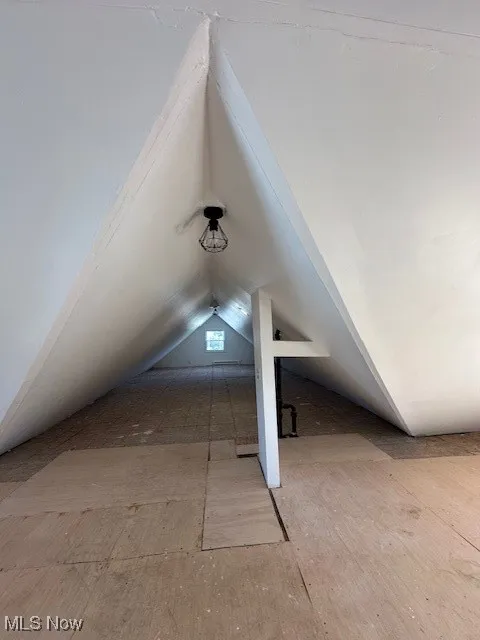 Additional living space featuring vaulted ceiling